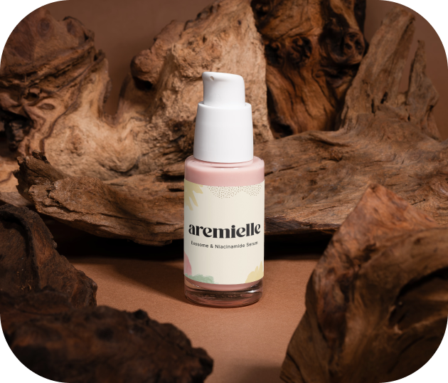 aremielle serum bottle placed among driftwood